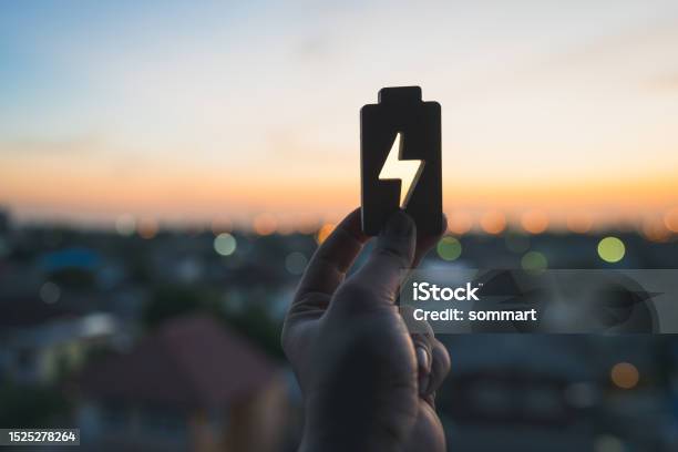 Technology Battery High Power Electric Energy With A Connected Charging Cable Battery To Electric Cars And Mobile Devices With Clean Electric Green Renewable Energy Battery Storage Future Stock Photo - Download Image Now