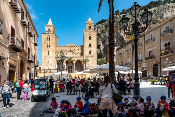 Cefalu Cathedral and square Cefalu, Italy - May 17, 2023: Square in front of cathedral in historic part of Cefalu town on Sicily Island cefalu stock pictures, royalty-free photos & images