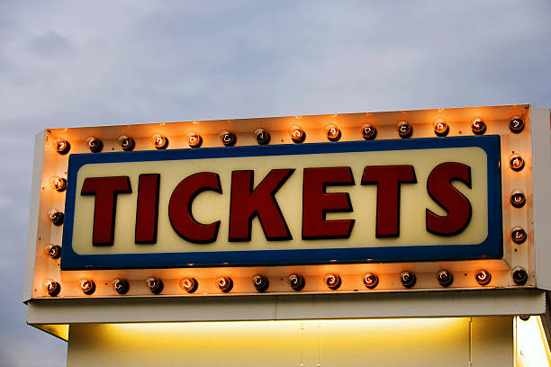 Tickets Ticket booth sign illuminated at twilight box office stock pictures, royalty-free photos & images