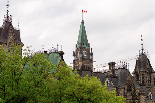 Parliament building with canadian flag in Ottawa, Canada