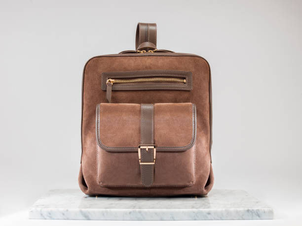istock Luxury suet backbag. Luxury brown leather and suet backpack
on white background, on marble floor. 1525340234
