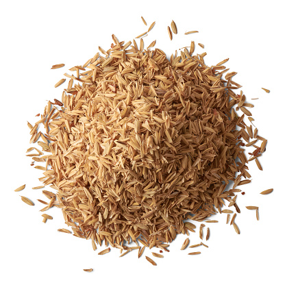 pile of paddy husk or rice husk, aka yellow rice chaff, rice husk or rice hull, outermost layer of the rice grain to use as animal feed, isolated on white background, taken from above