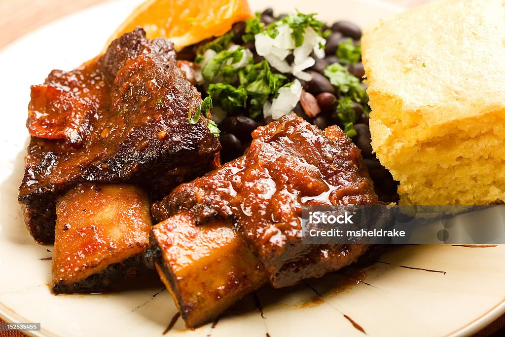 Spicy Braised Beef Ribs Tender braised beef ribs accompanied by black beans and cornbread Rib - Food Stock Photo
