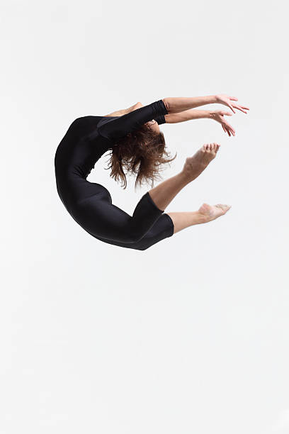 istock Female dancer jumps and touches toes 152535609