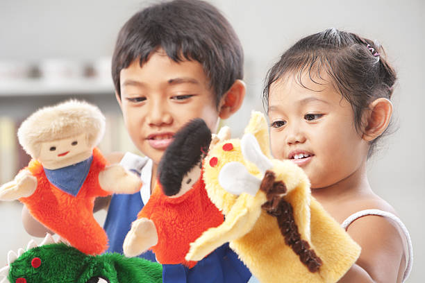 Sibling playing hand puppet Sibling playing hand puppets, which were  handmade puppet stock pictures, royalty-free photos & images