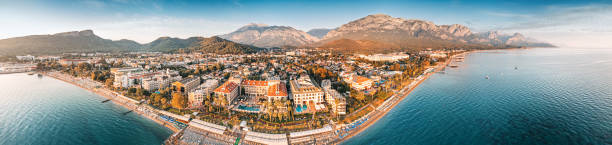 istock Indulge in a captivating visual journey with mesmerizing aerial shot, revealing a panoramic vista of Kemer's hotels harmoniously nestled between a picturesque sea beach and awe-inspiring mountains. 1525358176