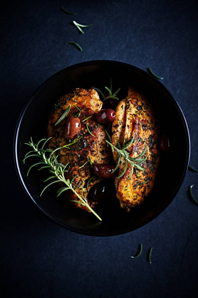 istock Roasted chicken breast with herbs and kalamata olives. Top view 1525363151