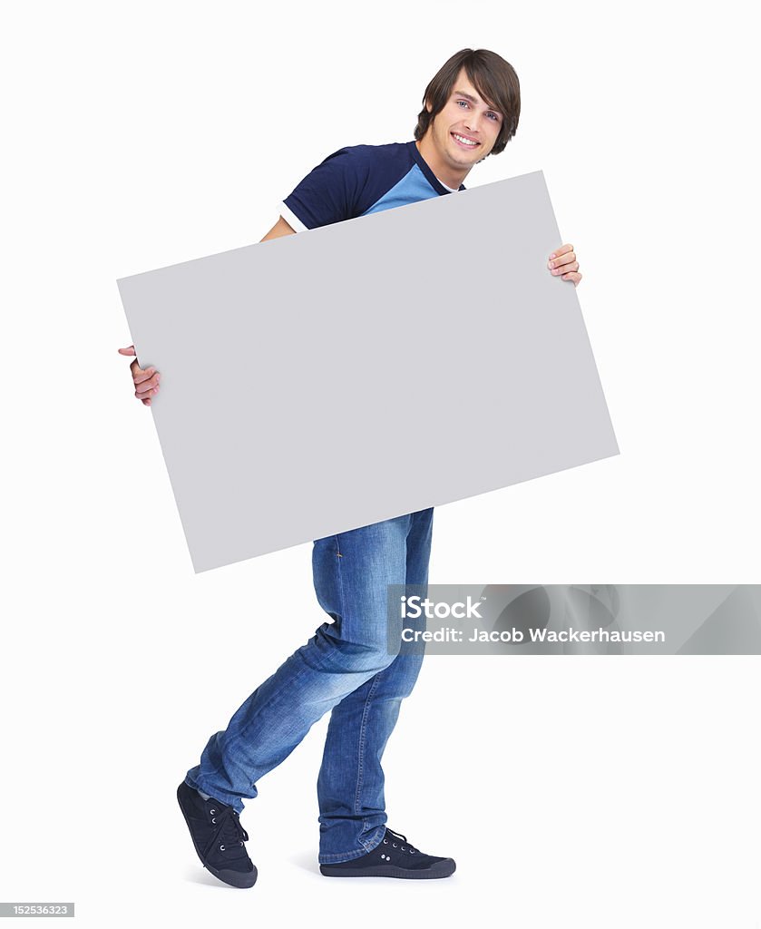 Portrait of a happy guy holding placard Portrait of a happy guy holding placard over white background Placard Stock Photo