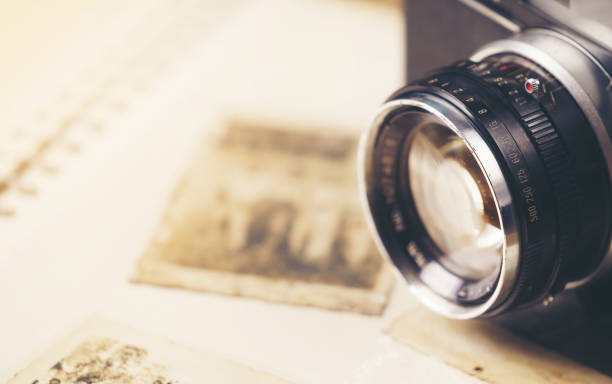 istock retro camera on the background of old photos 1525364653