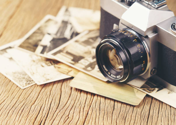 istock retro camera on the background of old photos 1525364837