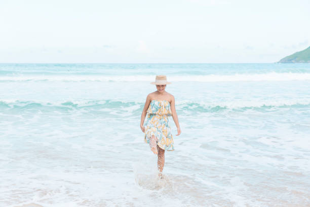 istock Happy Woman Discovers Beach Delights on Her Journey 1525364873