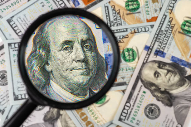 istock Hundred dollar banknote under magnifying glass close up 1525364968