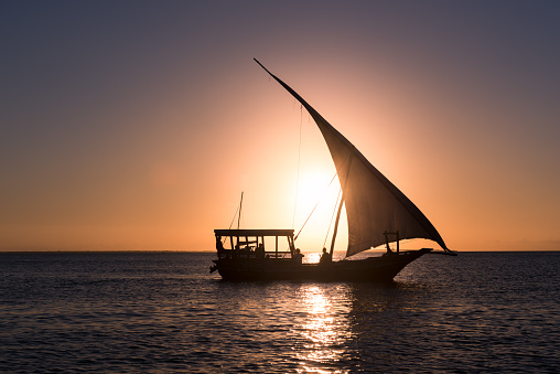 Old fashioned boat in front of the sunset in the Indian ocean