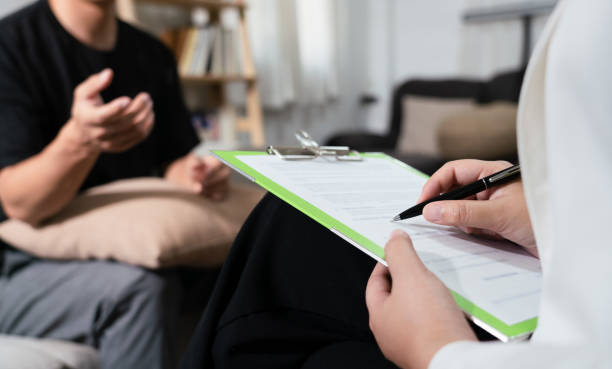 istock Psychologist is diagnostic examination and taking note while talking with man mental health problem 1525367207
