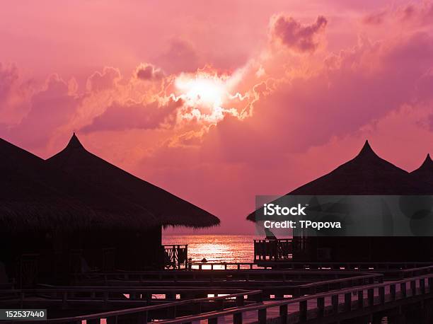 Human Silhouette In Water Bungalow At Sunset Stock Photo - Download Image Now - Adult, Back Lit, Building Exterior