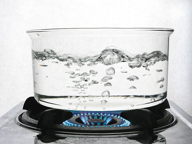 Boiling Water on Gas Water boiling in a clear glass pot. boiling stock pictures, royalty-free photos & images