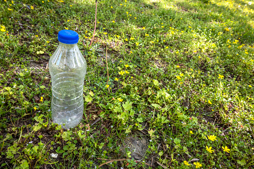 Plastic bottle of drinking water on the ground