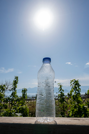 Plastic bottle of drinking water on the ground