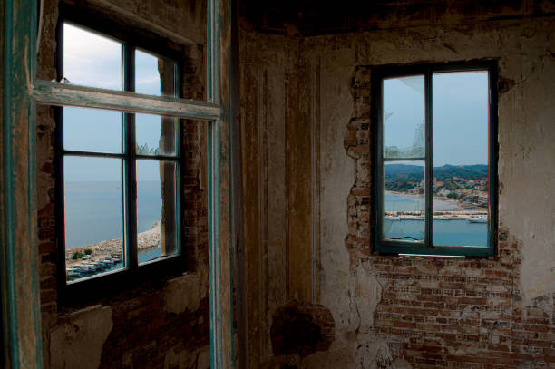 An aged wooden window set into a weathered stone wall exudes rustic charm and nostalgia. The scene captures the enduring beauty of craftsmanship and the passage of time.