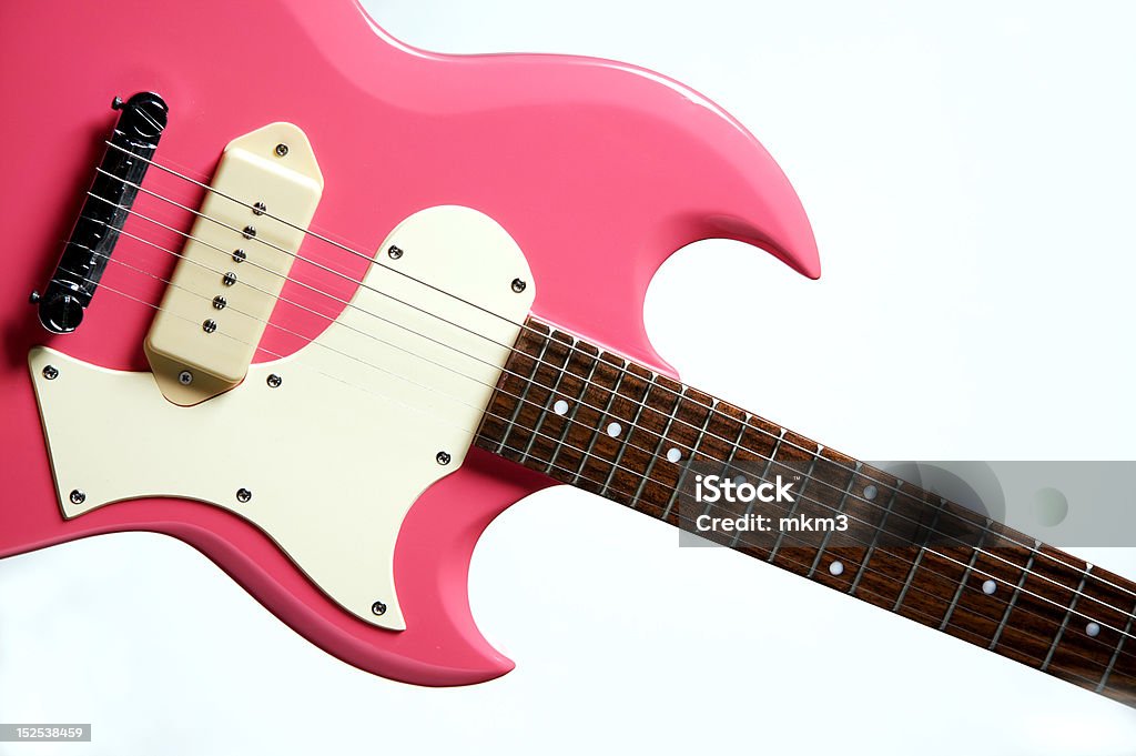 Pink Electric Guitar Isolated on White A pink electric guitar isolated against a white background in the horizontal format. Pink Color Stock Photo