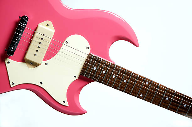 Pink Electric Guitar Isolated on White A pink electric guitar isolated against a white background in the horizontal format. pink guitar stock pictures, royalty-free photos & images