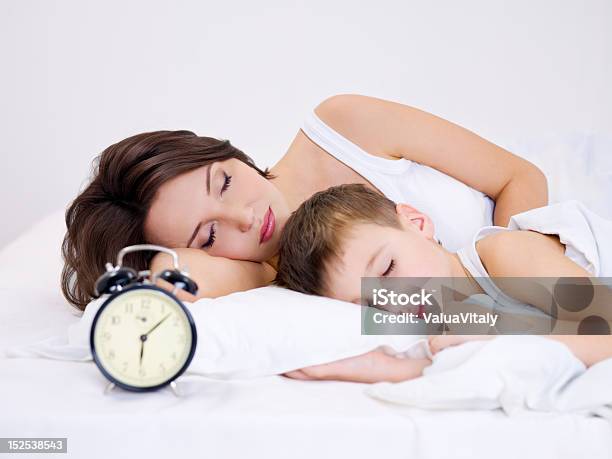 Mother And Son Sleeping Stock Photo - Download Image Now - Adult, Alarm Clock, Beautiful People