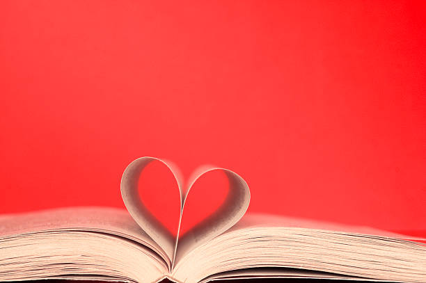 istock Heart in book from sheets at red background 152538805