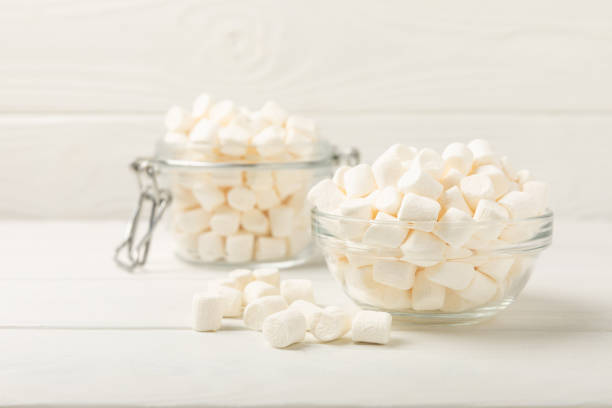 istock Marshmallow in a glass bowl on a white texture background.Rustic style.Gummous candy close-up.Snacks and snacks for parties.Spice for coffee and cocoa.Winter food concept.Place for text.Place for copy 1525393362