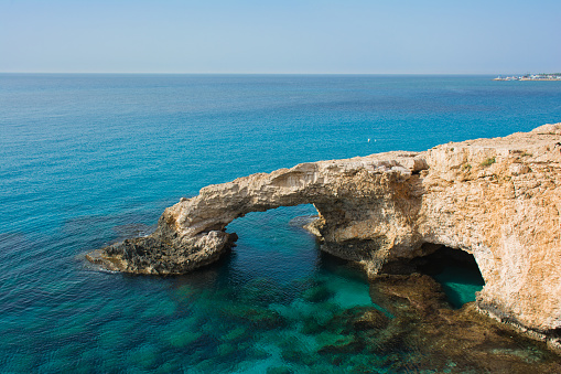 Bridge of Lovers - beautiful natural arch - on the background of blue sky. Agia Napa, Cyprus.
