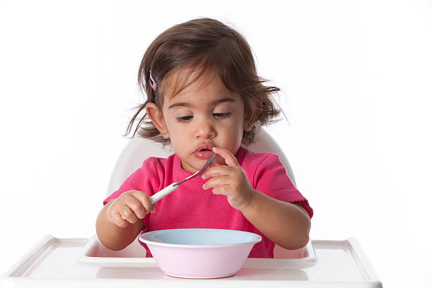 istock Baby girl touches her fork 152539575