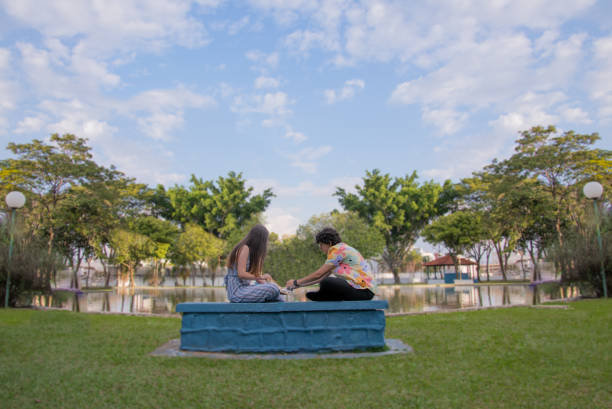 Same-sex female couple outdoors playing chess