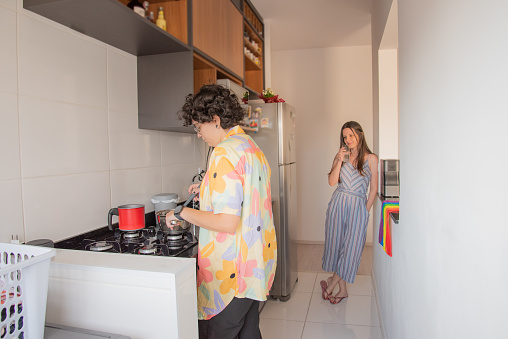 homoaffective couple of women interacting in the kitchen