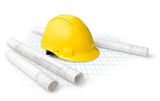 istock Yellow construction hat in the middle of building plans 152539744
