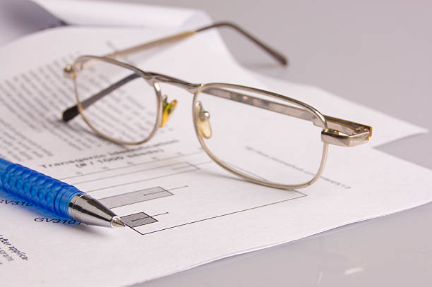 spectacles with ball-point pen stock photo