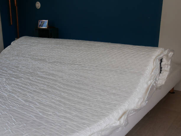 istock installation of a vacuum-rolled mattress on a bed 1525414107