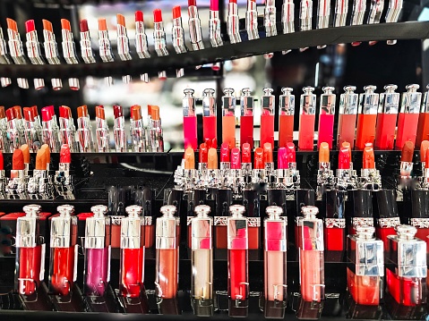 Different shades of lipstick displayed in a row in the cosmetics store.