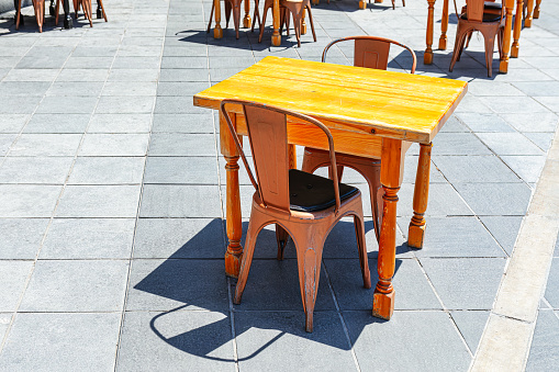 Wooden table and chairs at outdoor cafe . Outdoor restaurant furniture