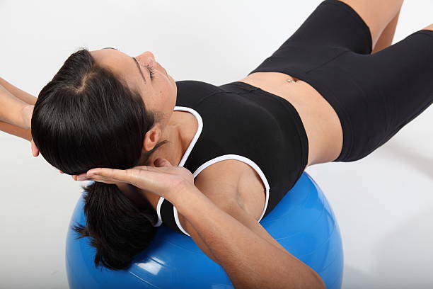 istock Fitness workout by young woman using exercise ball 152542381