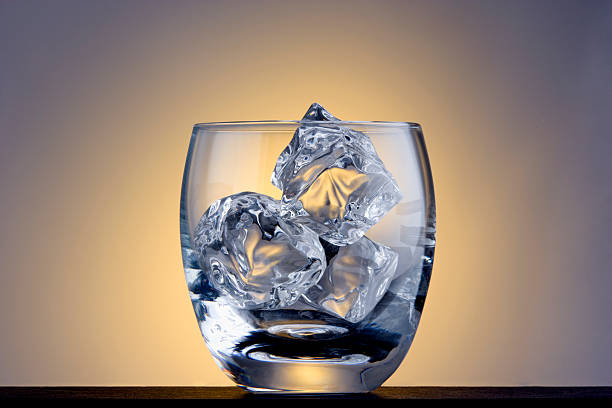 Empty glass with ice cubes stock photo