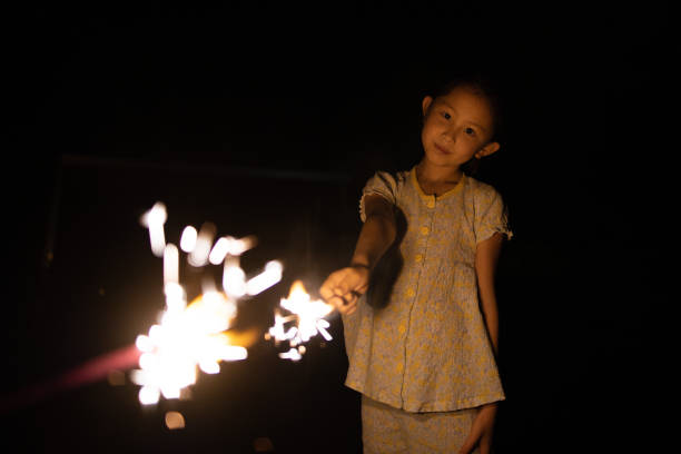 Girl enjoying fireworks on a summer night