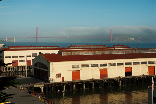 Fort Mason's docks in the morning sunlight as the Golden Gate Bridge lays beyond.