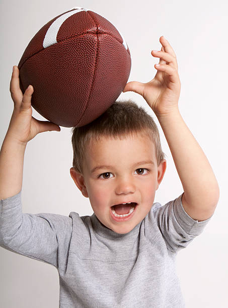 istock Toddler Catching Football 152543812