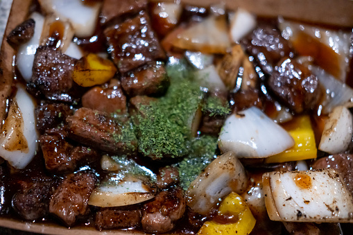 Close up of fried diced steak with vegetables and onion. Korean street food