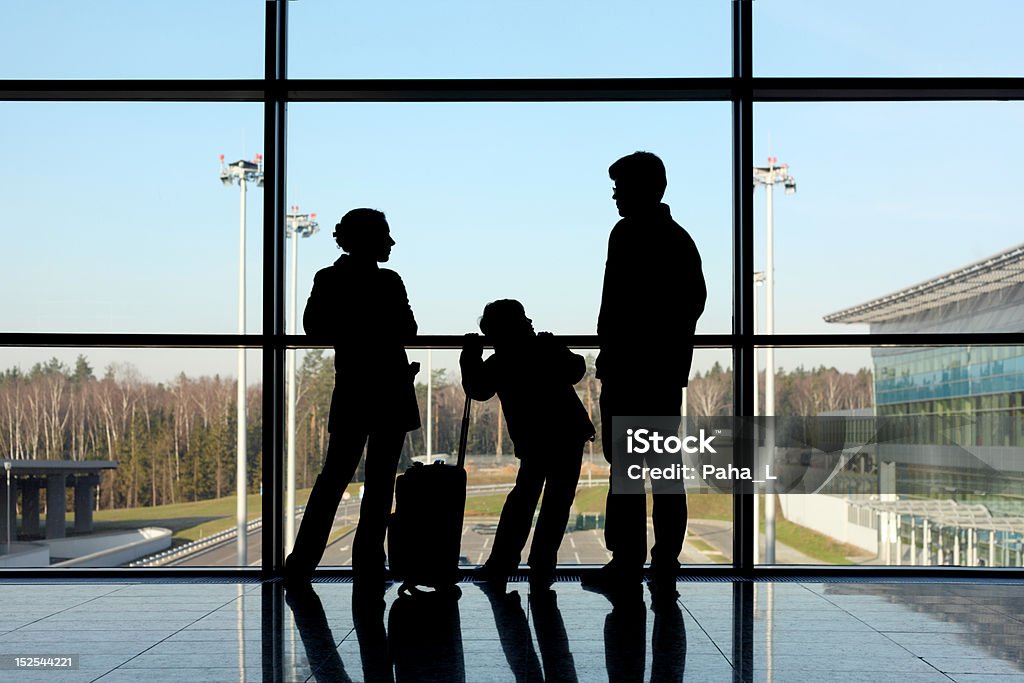 Silhouette der Familie mit Gepäck steht in der Nähe vom Fenster nachdenkt. - Lizenzfrei Eltern Stock-Foto