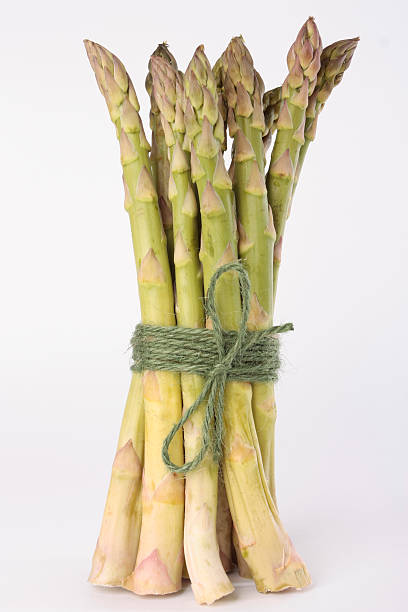 istock Bunch of asparagus over white background 152544261