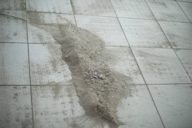 Old broom and rusty old dust pan on swimming pool floor, pool service and maintenance