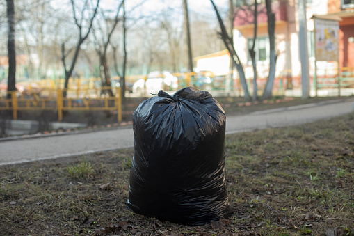 Garbage bag. Black Waste Bag. Plastic bag. Details of street cleaning.
