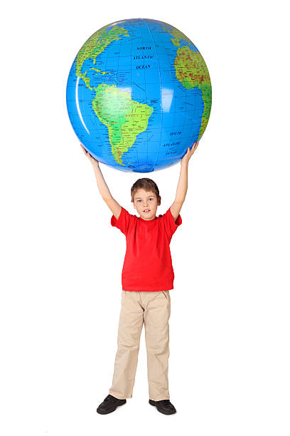 Boy holding big inflatable globe over his head
