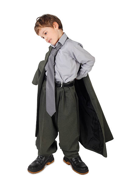 istock Boy in big grey man's suit and boots dressing jacket 152544566