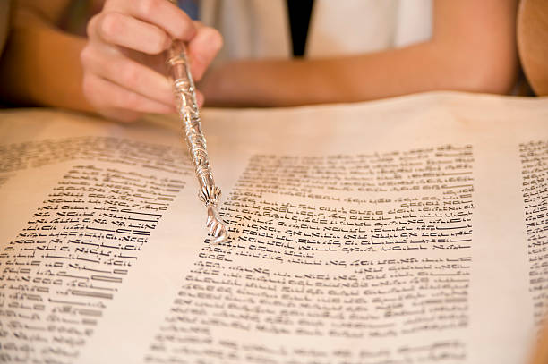Reading the Torah during Bat Mitzvah Reading the Torah in Hebrew with a yad as part of a teenage girl's Bat Mitzvah (coming of age) ceremony at a Jewish Temple / synagogue. hasidism photos stock pictures, royalty-free photos & images